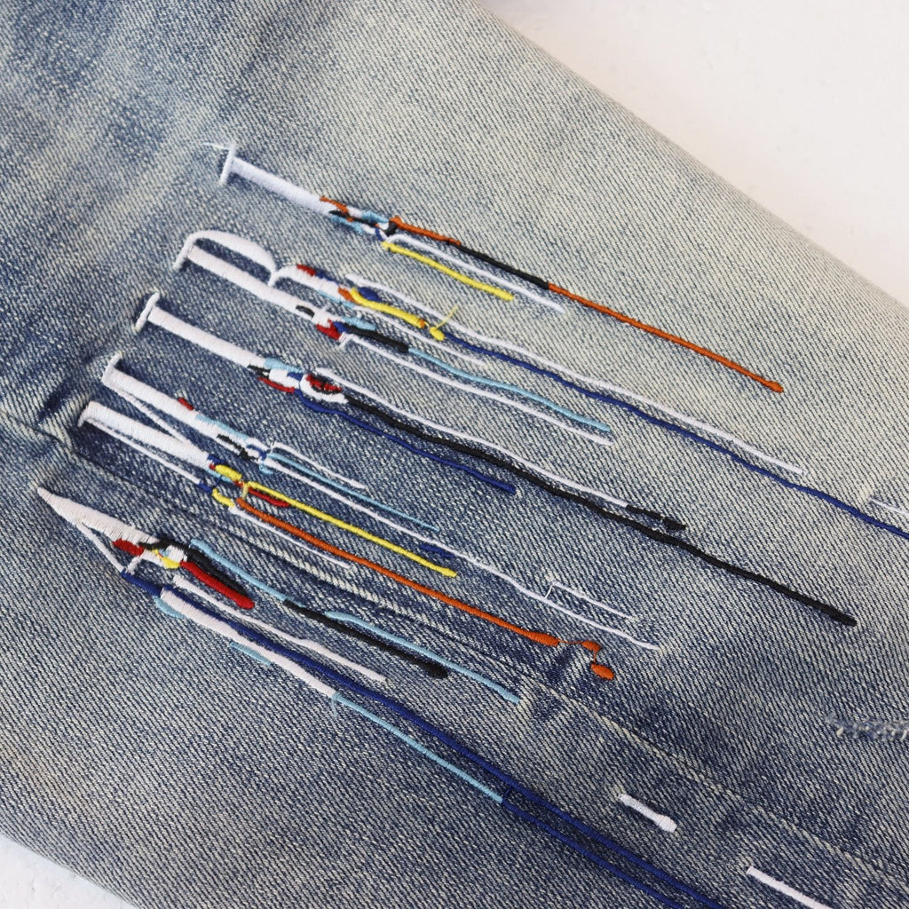 AMIRI Sinners Distressed Skinny Jeans — detail